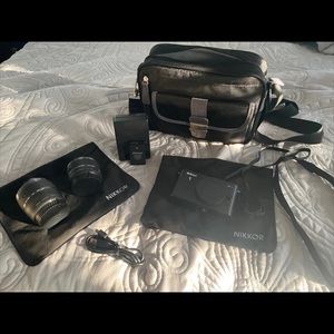 Nikon 1J1 Mirrorless Camera with 2 Lenses, Battery, Charger, Camera Bag, and USB